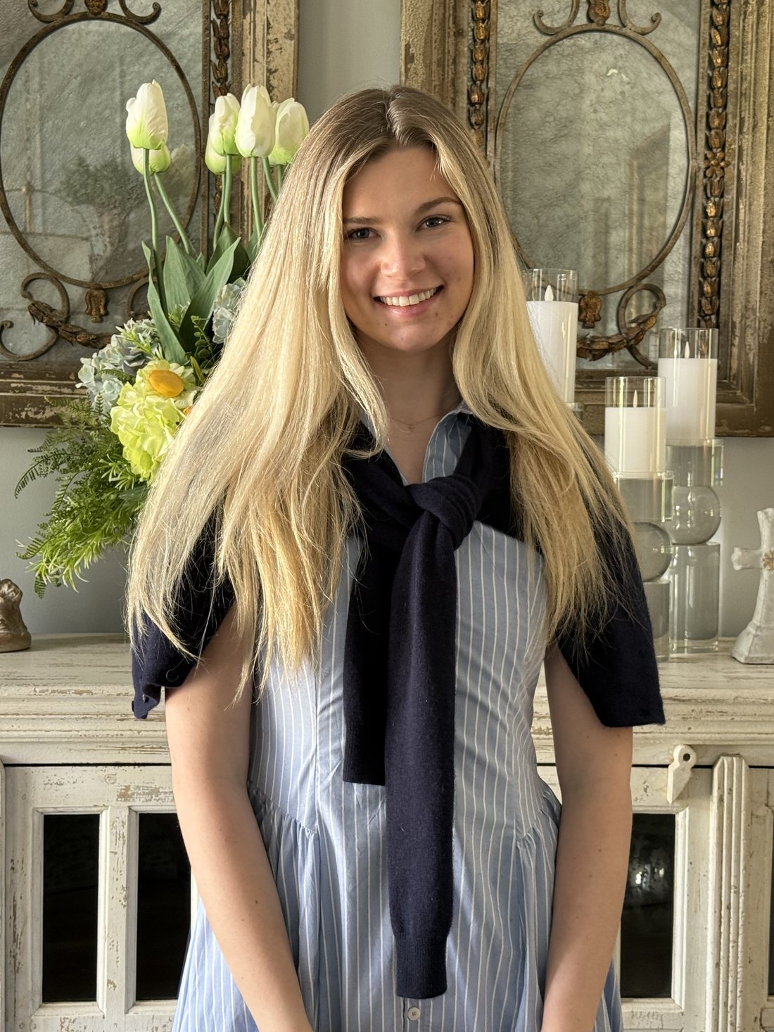 Avery smiling in a blue striped dress